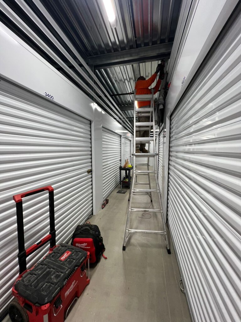 View showing multiple solar arrays on connected Public Storage facility buildings.