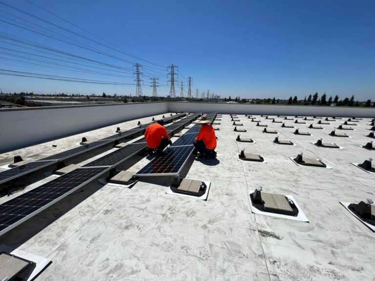 Solar panels installed on a sloped section of the Public Storage roof.
