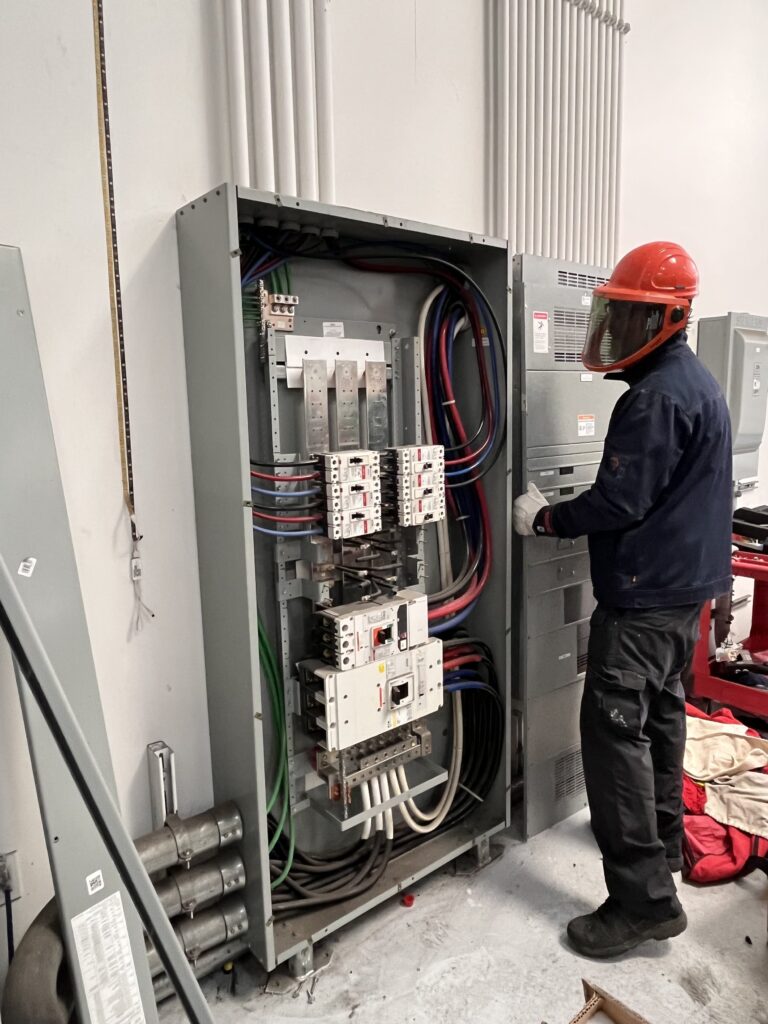 Vertical view of a clean, well-lit service bay with upgraded electrical features.